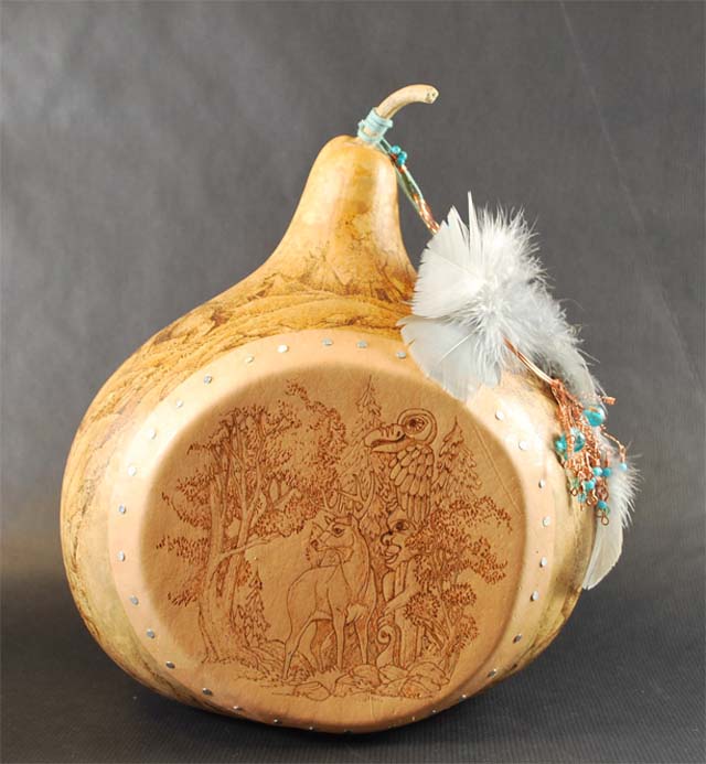 For this drum, Lora burned both the gourd and its leather face. She notes that leather is especially easy to burn.
